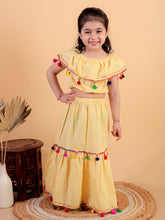 Yellow pure cotton crop top and long skirt embellished with pompom tussal