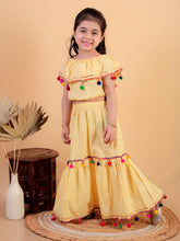 Yellow pure cotton crop top and long skirt embellished with pompom tussal